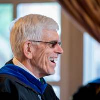 faculty member laughing while waiting for program to start